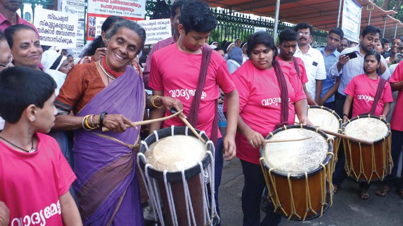 Activist Daya Bai peforms on chenda with children with special needs during their 7-hour fast in Thiruvananthapuram on Monday. (Photo: A.V. MUZAFAR)