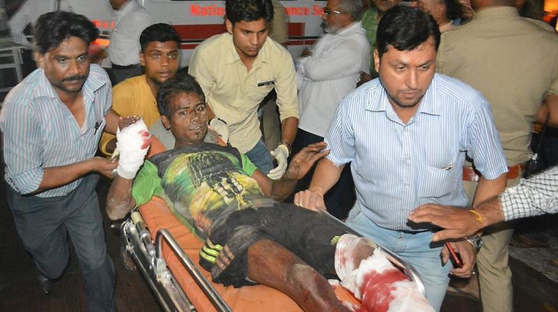 A victim is being taken away for treatment as rescue operations continue at the accident site where coaches of the Puri-Haridwar Utkal Express train were derailed. (Photo: PTI)
