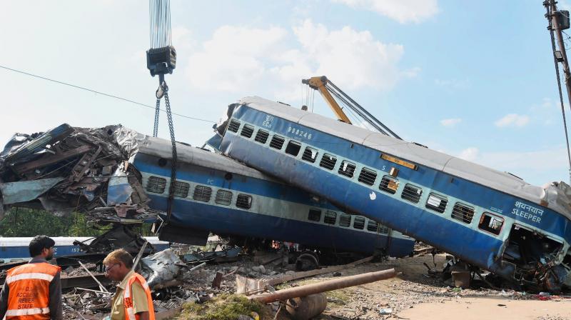 A mangled coach of the Puri-Haridwar Utkal Express train being hauled off the tracks by a crane, at the accident site in Khatauli near Muzaffarnagar on Sunday. (Photo: PTI)