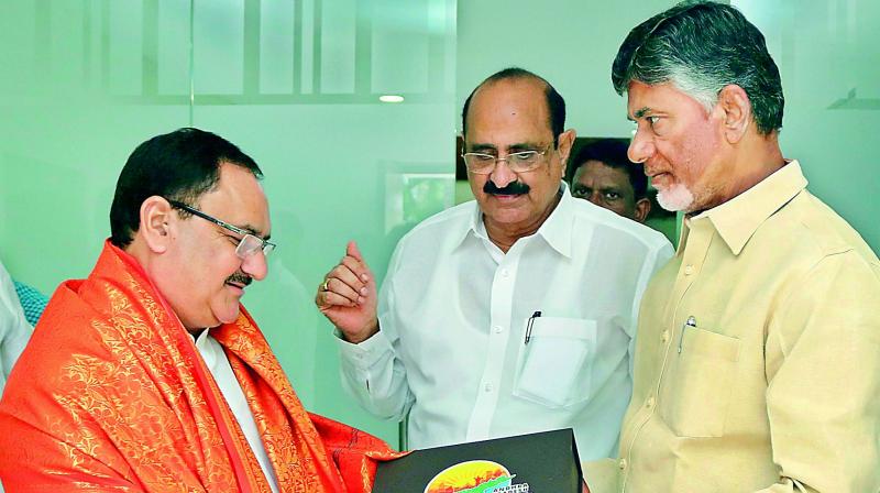 Chief Minister N. Chandrababu Naidu felicitates Union Health Minister J.P. Nadda at his house near Vijayawada on Tuesday. (Photo: DC)