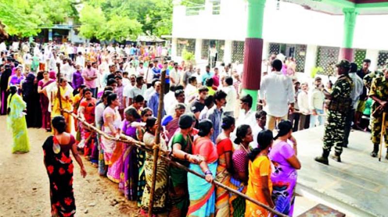 Voters in large numbers stand in queue to cast their vote at a polling booth in Nandyal on Wednesday. (Photo: DC)