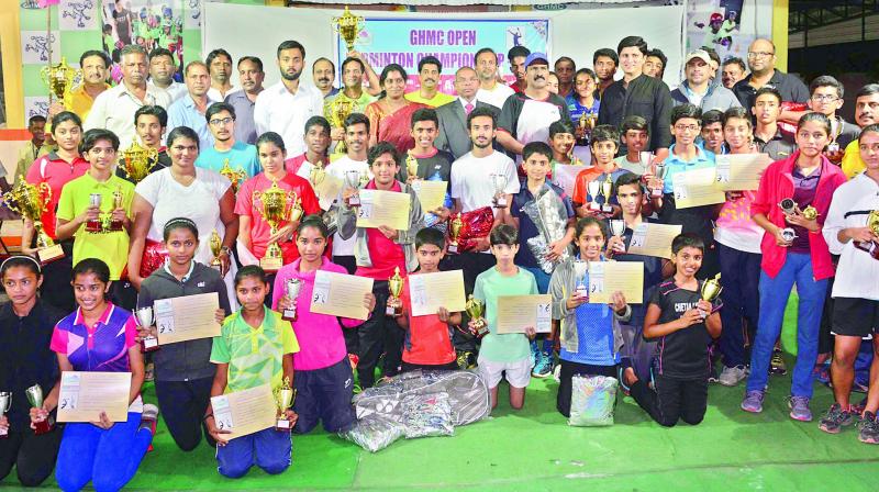 Winners in the various categories pose with their trophies and certificates in the recently concluded GHMC Annual Open Badminton Championship at the GHMC Ameerpet Sports Complex.