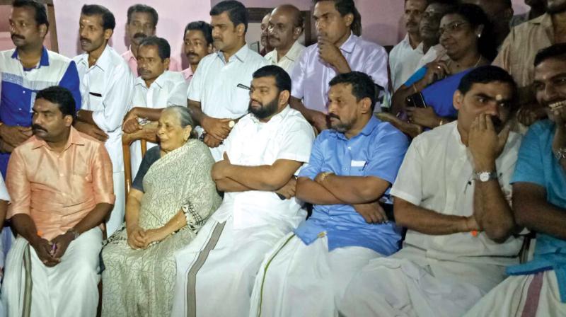 Brigitta, mother of Alphonse Kannanthanam, BJP district president N. Hari and  others watch his swearing-in ceremony at Alphone House at Manimala in Kottayam on Sunday. (Photo: DC)