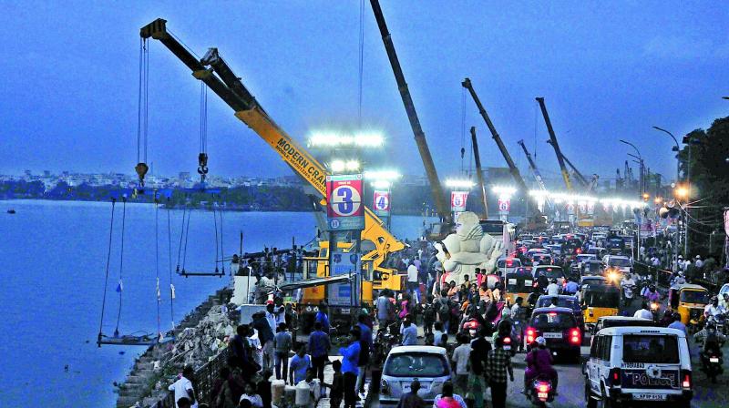 Cranes set up along the Hussainsagar to carry out immersions. Over 10 lakh people are expected to join the processions. (Photo: DC)