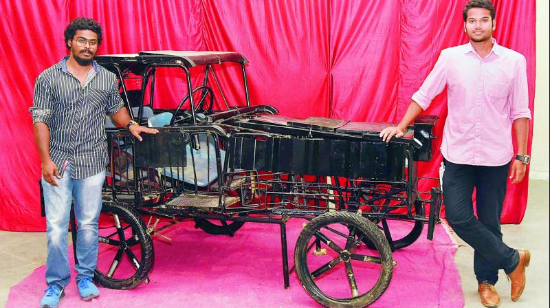 Prasanna and Pruthvi along with their car made out of scrap metals and broken chairs.