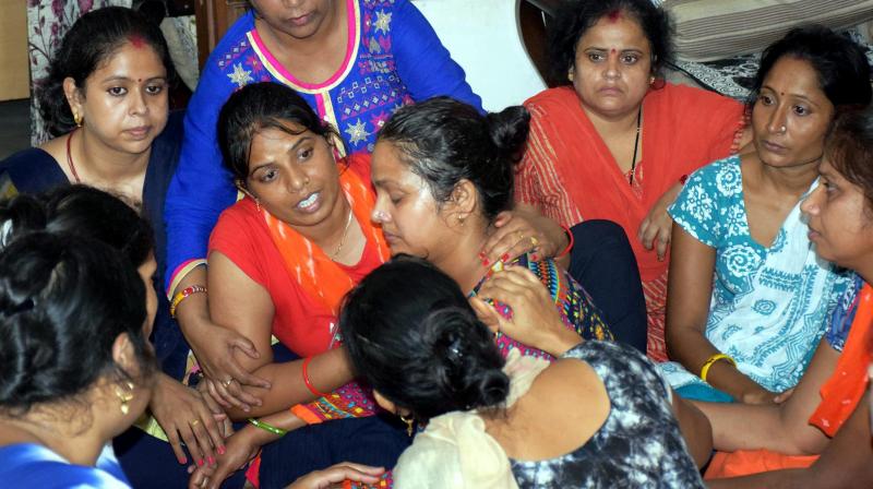 Relatives console mother of the student who was allegedly murdered at Ryan International School in Gurugram. (Photo: PTI)