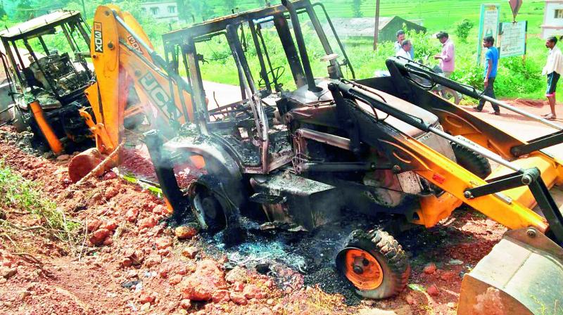 Maoists torched four JCBs engaged in optical fibre network in Vizag Agency on Friday. (Photo: DC)