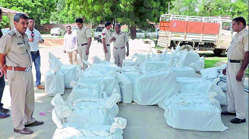 Police with recovered 84 cartons of firecrackers and explosive materials from the Dera premises on Saturday. (Photo: PTI)