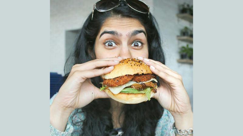 Carolyn, a city-based foodie poses with a healthy Quinoa burger.