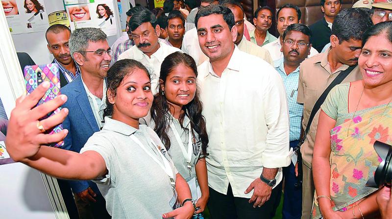 IT Minister Nara Lokesh poses for a selfie with the youngsters at the International Innovation Fair in Visakhapatnam on Sunday. (Photo: DC)