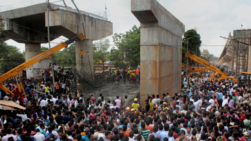 People crowd near the site of mishap where an under-construction ovebridge collapsed at Bomikhal in Bhubaneswar. (Photo: PTI)