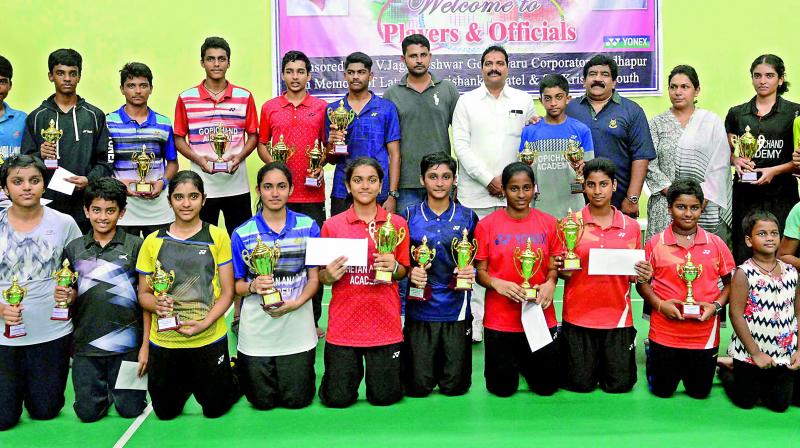Winners and runners-up pose with the trophies after the conclusion of the 3rd Telangana State Sub-Junior (boys & girls) Badminton Championship that was played at the Sri Fit Pro Badminton House in Serlingampally.