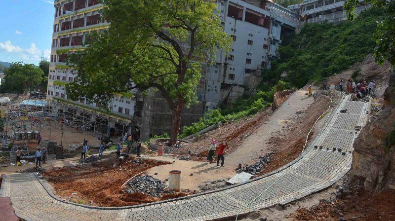 Kanakadurga temple officials construction road near Mallikharjuna Mahamandapam in Vijayawada on Tuesday.(Photo: DC)