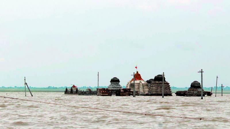 The Sangameshwara temple in the foreshores of the Srisailam reservoir goes under water on Sunday. Pujas are performed to the temple before it is submerged, which is an annual event when the dam gets water. (Photo: DC)