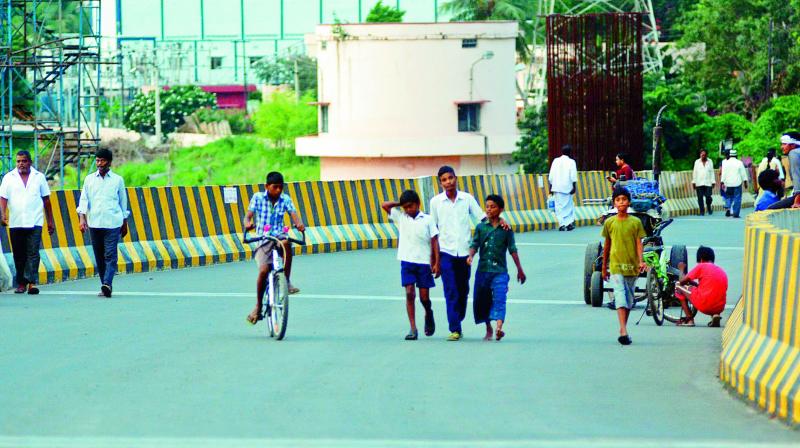 People are barred from using even a two-wheeler on the newly laid flyover near Kanakadurga temple in Vijayawada on Monday. (Photo: DC)