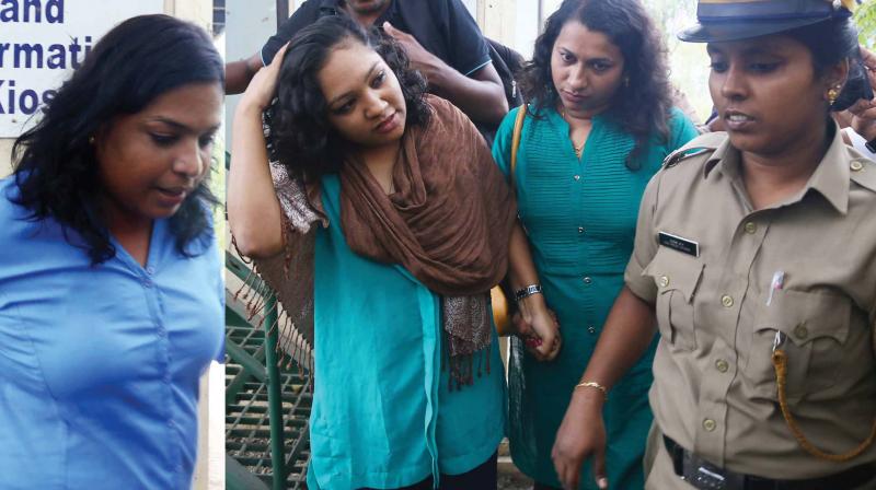The three women who allegedly assaulted a Uber taxi driver at Vytilla in Kochi on Wednesday being taken into custody by the police. (Photo: DC)