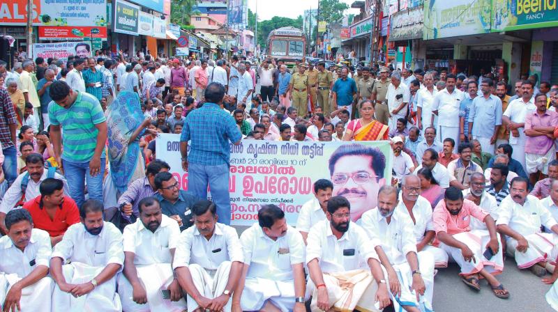 Agitators block the national highway at Parassala in Thiruvananthapuram demanding the arrest of the accused in the Nirmal Krishna Chit Fund scam on Wednesday. (Photo: DC)