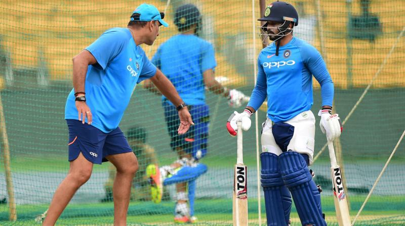 Team India coach Ravi Shastri gives tips to Kedar Jadhav during a practice session at M Chinnaswamy Stadium in Bengaluru on Wednesday, ahead of the 4th One Day International cricket match against Australia. (Photo: PTI)