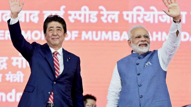Prime Minister Narendra Modi and the Prime Minister of Japan, Shinzo Abe waves at the crowd at the foundation laying ceremony of Indias first bullet train project between Ahmedabad and Mumbai, in Ahmedabad. (Photo: PTI)