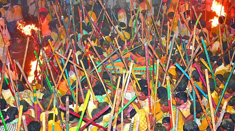 Groups of villagers clash with sticks for the idols belonging to a temple as part of the annual Banni festival in Kurnool district.  (Photo: DC)