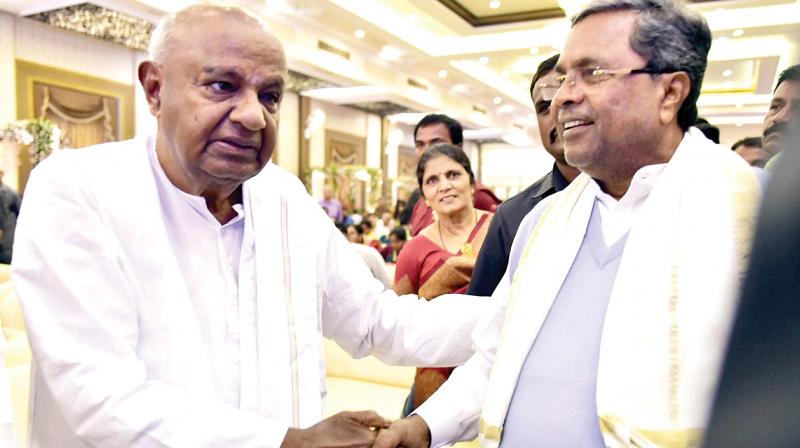 JD(S) chief H.D. Deve Gowda greets CM Siddaramaiah at the engagement of his grandson Dr Suraj Revanna, son of H.D. Revanna, in Bengaluru on Monday. (Photo: KPN)