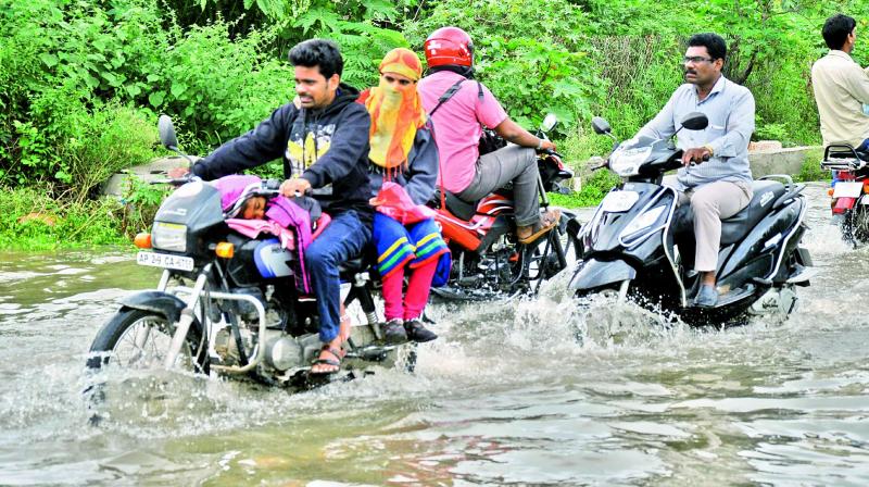 Motorists negotiate a flooded road in Nacharam on Tuesday. (Photo: DC)