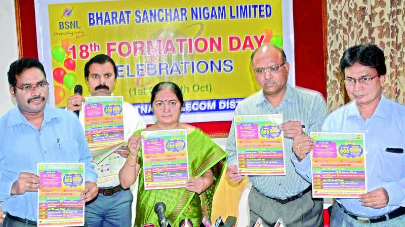 Principal General Manager of BSNL, Vizag Region, Nalini Varma along with her staff release a poster during a meeting at the BSNL office in Visakhapatnam on Tuesday.