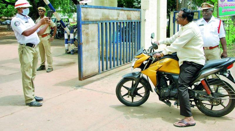 Police implement the No helmet-No entry rule strictly at the DPO in Guntur from Tuesday. (Photo: DC)