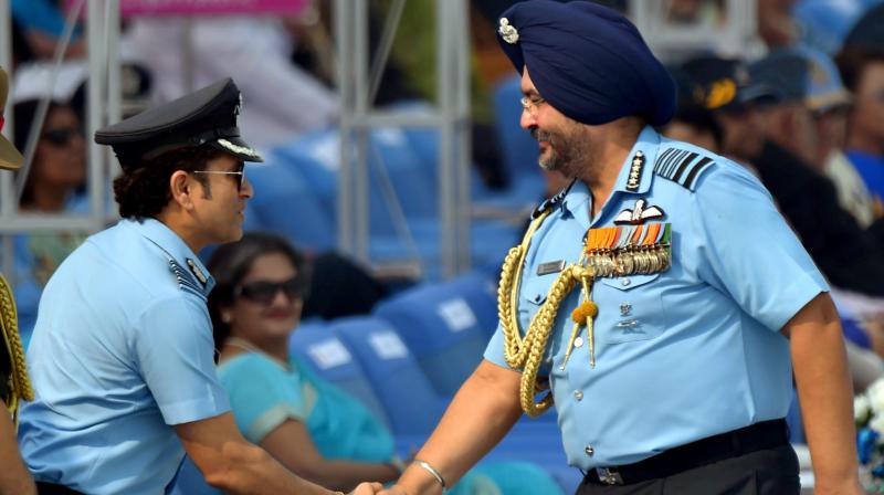 Captain of IAF, Sachin Tendulkar (L) being greeted by Air Chief Marshal BS Dhanoa during the 85th Air Force Day parade at Hindon Air Force base in Ghaziabad on Sunday. (Photo: PTI)