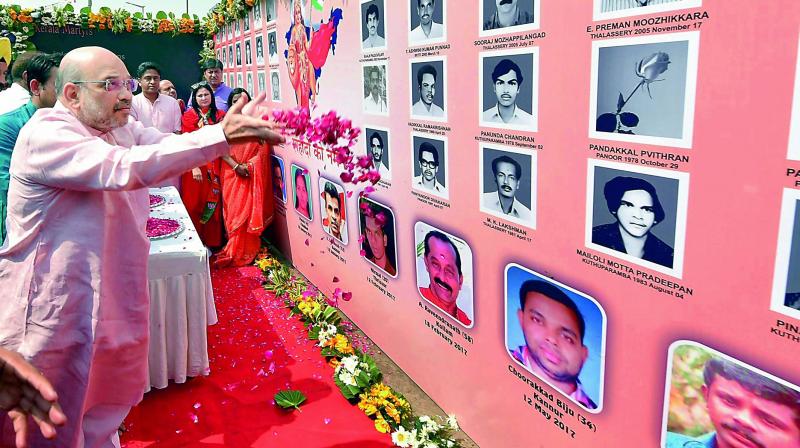 BJP president Amit Shah pays homage to party workers who were allegedly murdered in Kerala, during Jan Raksha Yatra in New Delhi on Sunday. (Photo: PTI)