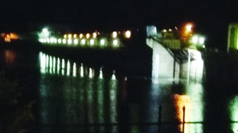 Lights are reflected in the Srisalam dam, where the water stood at 883 feet, against the full reservoir level of 885 feet on Sunday. (Photo: DC)