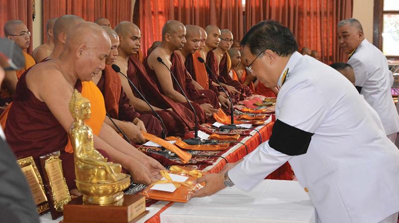Vitavas Srivihok, Deputy Permanent Secretary, Ministry of Foreign Affairs, Thailand offering the Royal Kathina Civara (special robe) to Buddhist monks at a function organised by the Maha Bodhi Society, Bengaluru.