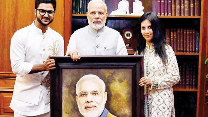 Artist Suvigya Sharma (L) and his wife Charu Suvigya Sharma (R) with Prime Minister  Narendra Modi.