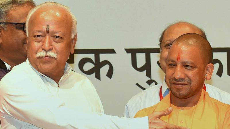 Uttar Pradesh Chief Minister Yogi Adityanath and RSS chief Mohan Bhagwat at the annual Bharatatma Ashokji Singhal Vedic Awards 2017 function in New Delhi on Thursday. (Photo: PTI)