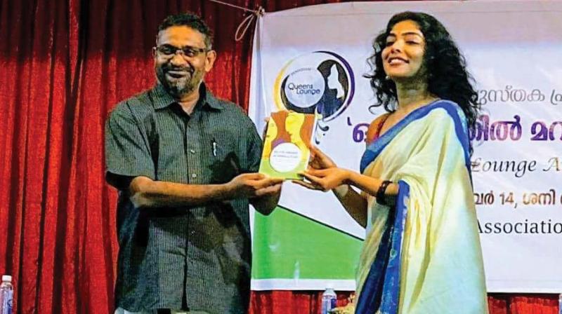 Writer Benyamin handing over the first copy of Ottanirathil Maranjirunnavar to actress Rima Kallingal.