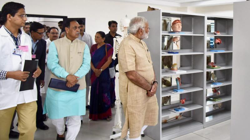 Prime Minister Narendra Modi during a visit to GMERS Medical College, Vadnagar, Gujarat on Sunday. Chief Minister of Gujarat, Vijay Rupani is also seen. (Photo: PTI)