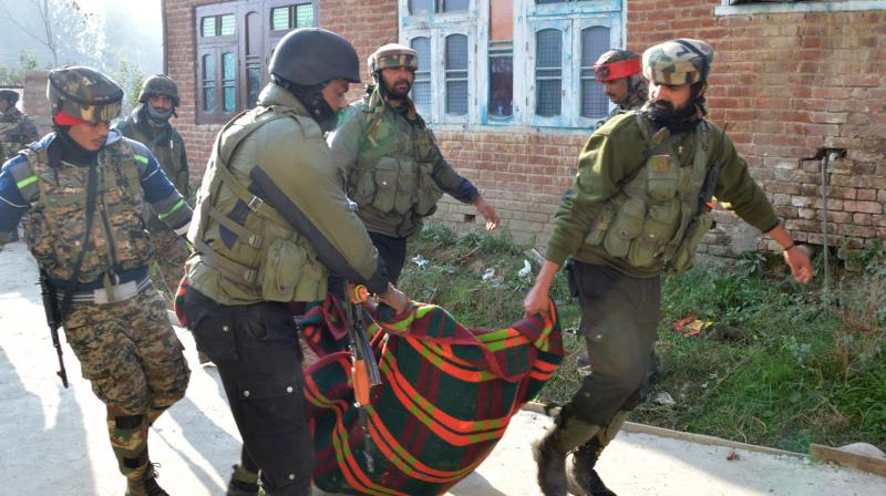 Army soldiers carry the body of a militant killed in a gunfight in Litter village of Pulwama district on Saturday. (Photo: H U Naqash)