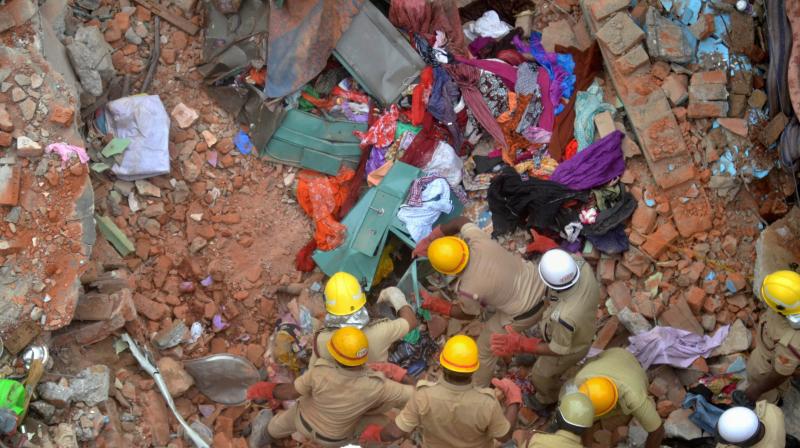 Fire personnel carrying out rescue work after a building collapsed due to a suspected cylinder blast at Ejipura area in Bengaluru on Monday. (Photo: PTI)