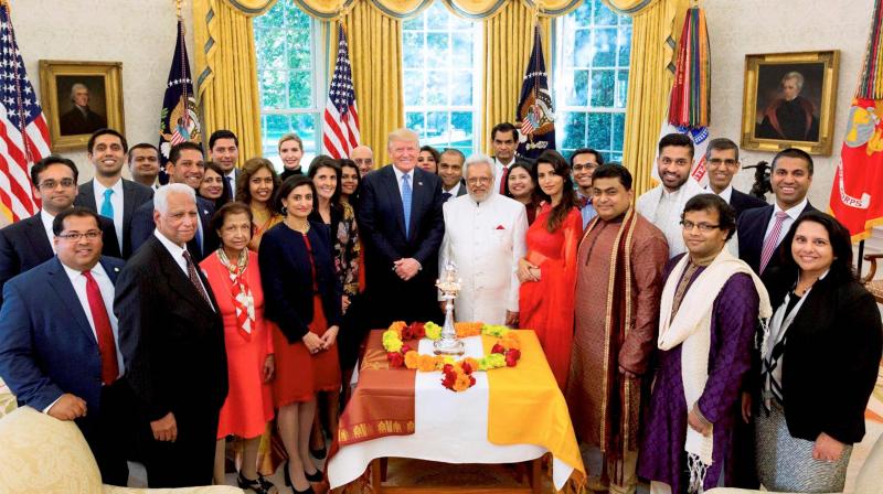 President Donald J. Trump poses in a group photo with U.S. United Nations Ambassador Nikki Haley, left, following a Diwali ceremonial lighting of the Diya in the Oval Office at the White House. (Photo: PTI)