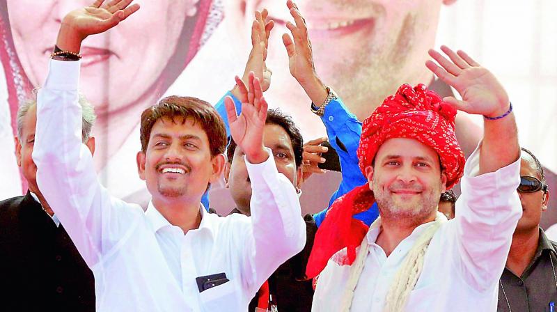 Congress vice-president Rahul Gandhi with OBC leader Alpesh Thakor who joined the party, during a public meeting in Gandhinagar, Gujarat on Monday. (Photo: PTI)
