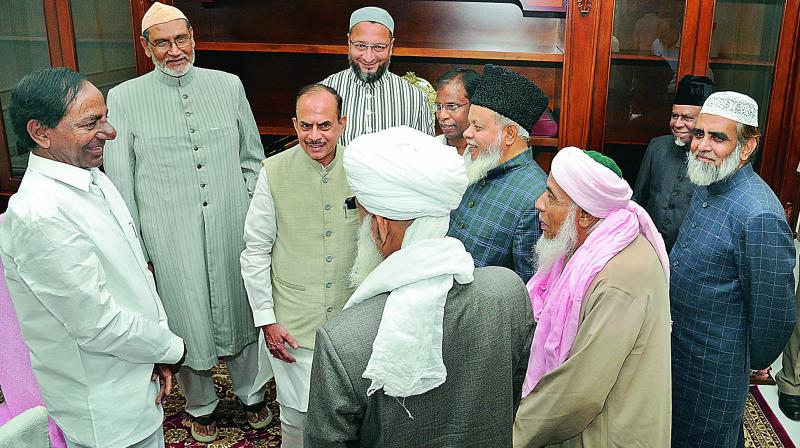 Chief Minister K. Chandrasekhar Rao interacts with Muslim community elders as Deputy Chief Minister Mohd. Mahmood Ali, Hyderabad MP Asaduddin Owaisi and senior IPS officer A.K. Khan look on, in Hyderabad on Monday.