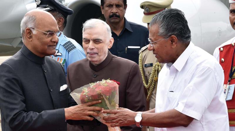 Chief minister Pinarayi Vijayan welcomes President Ram Nath Kovind at Thiruvananthapuram airport on Friday. Governor P. Sathasivam looks on. (Photo: Peethambaran Payyeri)