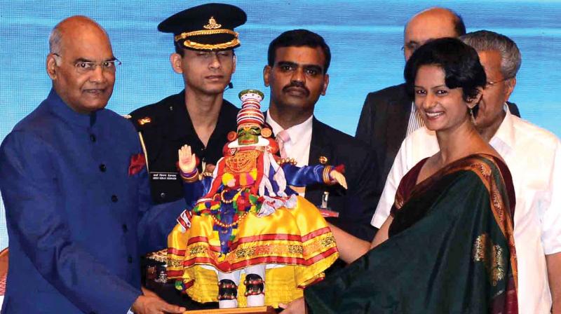 Thiruvananthapuram District collector K. Vasuki presents a memento to President Ram Nath Kovind during a civic reception accorded to him in the state capital on Friday. (Photo: Peethambaran Payyeri)