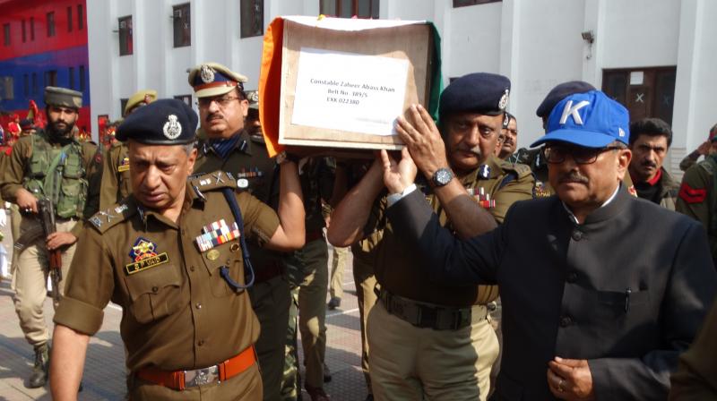 J&Ks Deputy Chief Minister, Nirmal Singh, Director General of Police, Shesh Paul Vaid, and Inspector General of Police (Kashmir range) Munir Ahmed Khan join the pallbearers at a wreath-laying ceremony for fallen policeman Zaheer Abbas Khan in Srinagar on Sunday.