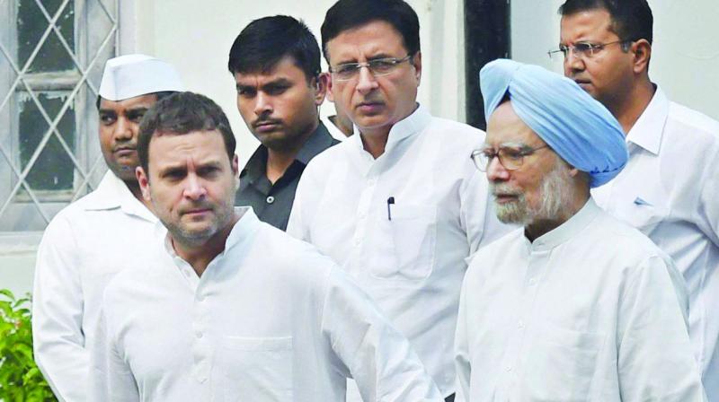 Congress V-P Rahul Gandhi with former PM Manmohan Singh and Randeep Surjewala leaves after a meeting on the November 8 protest against demonetisation, in New Delhi on Monday. (Photo: PTI