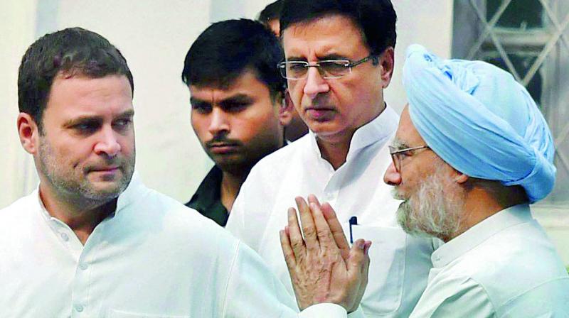 Congress vice-president Rahul Gandhi with former Prime Minister Manmohan Singh and Randeep Surjewala in New Delhi on Monday. (Photo: PTI)