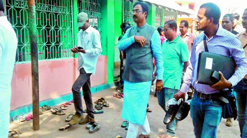 Union ministers personal assistant carrying his shoes in Odisha on Monday. (Photo: Agencies)