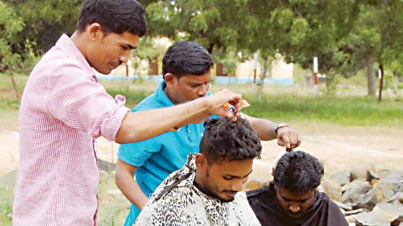 Kalaburgi rowdies being given haircut after a parade on Monday. 	(Photo: DC)