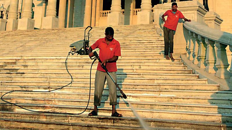 Workers clean Suvarna Soudha in Belagavi on the eve of the winter  session of the legislature. 	(Photo:  DC)