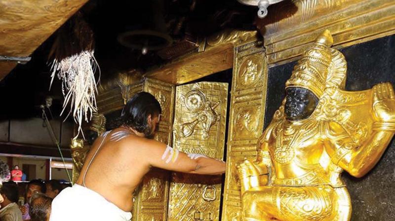 Melsanthi T. M. Unnikrishnan Nampoothiri opens the  sanctum sanctorum.